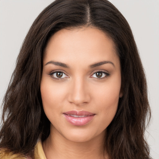 Joyful white young-adult female with long  brown hair and brown eyes