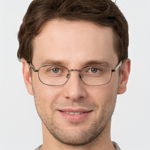 Joyful white adult male with short  brown hair and grey eyes