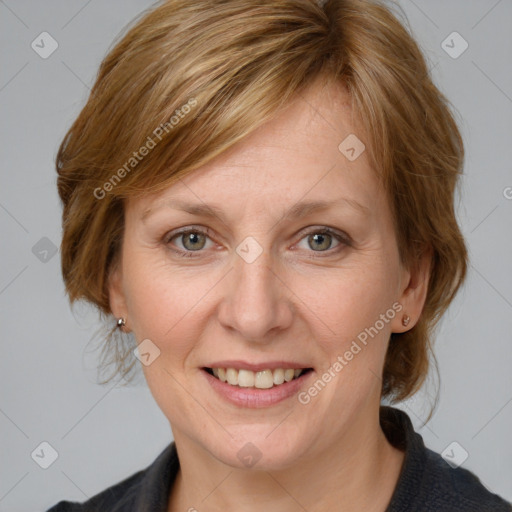 Joyful white adult female with medium  brown hair and blue eyes