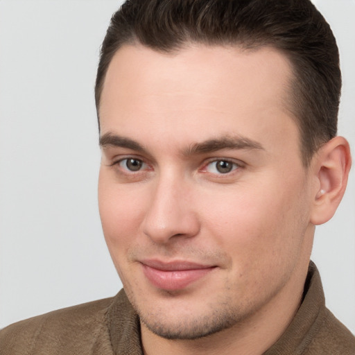 Joyful white young-adult male with short  brown hair and brown eyes