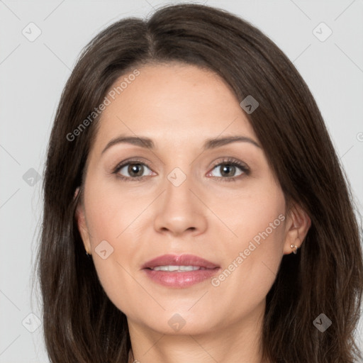 Joyful white adult female with long  brown hair and brown eyes