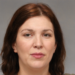 Joyful white adult female with medium  brown hair and brown eyes