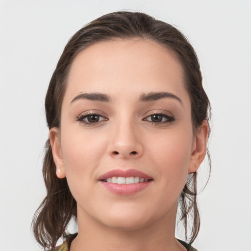 Joyful white young-adult female with medium  brown hair and grey eyes