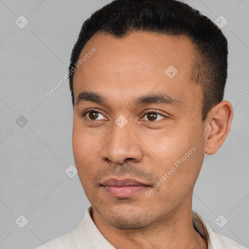 Joyful latino young-adult male with short  black hair and brown eyes