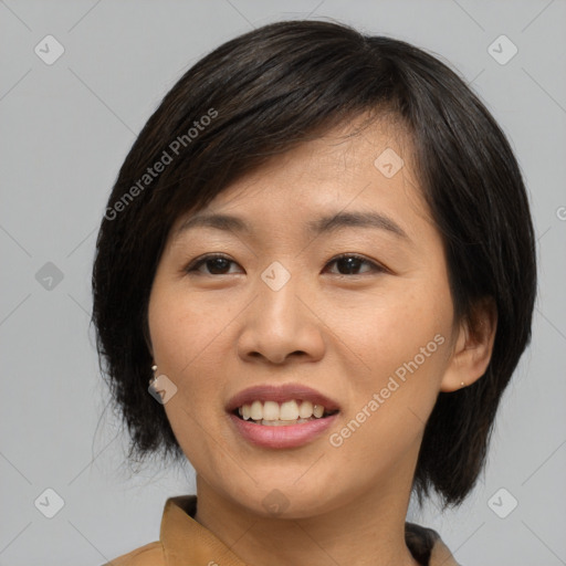 Joyful asian young-adult female with medium  black hair and brown eyes