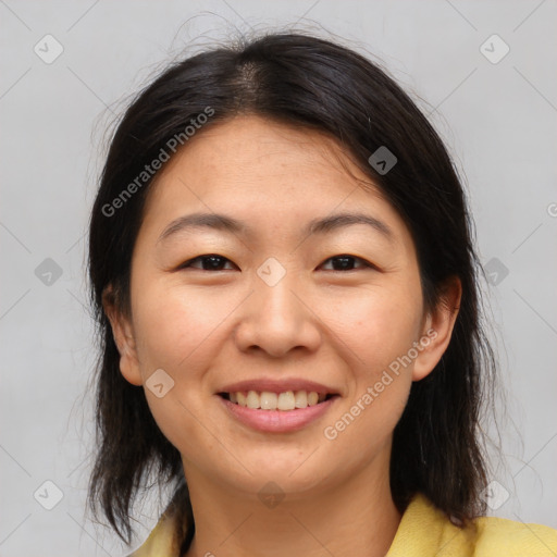 Joyful asian young-adult female with medium  brown hair and brown eyes