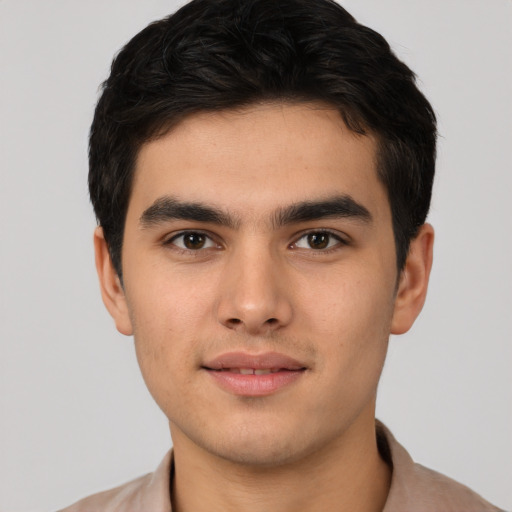 Joyful white young-adult male with short  brown hair and brown eyes