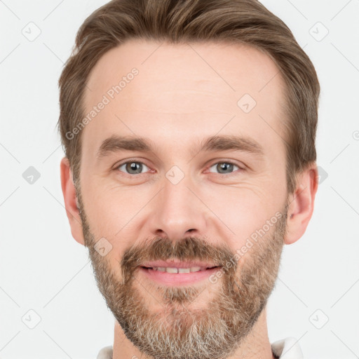 Joyful white adult male with short  brown hair and grey eyes