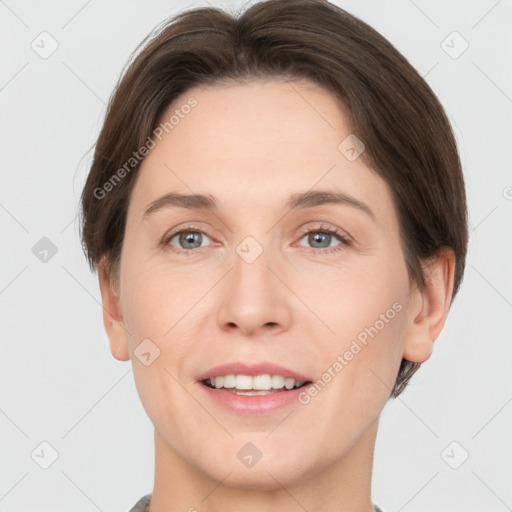 Joyful white adult female with short  brown hair and grey eyes