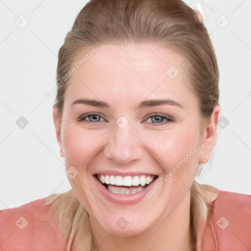 Joyful white young-adult female with long  brown hair and blue eyes