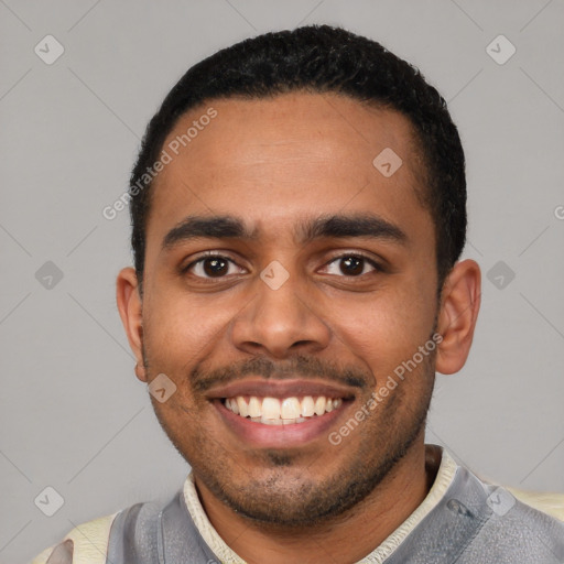 Joyful black young-adult male with short  black hair and brown eyes