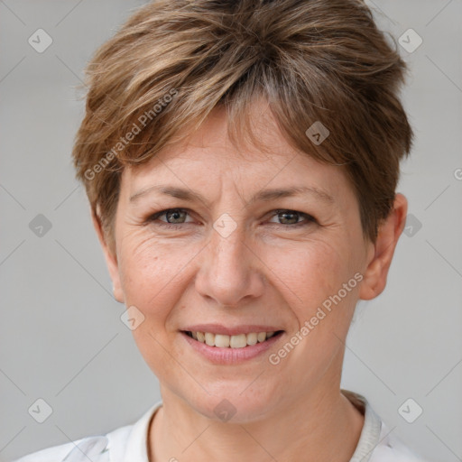 Joyful white adult female with short  brown hair and grey eyes