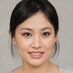 Joyful asian young-adult female with medium  brown hair and brown eyes