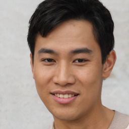 Joyful asian young-adult male with short  black hair and brown eyes