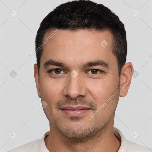 Joyful white young-adult male with short  black hair and brown eyes