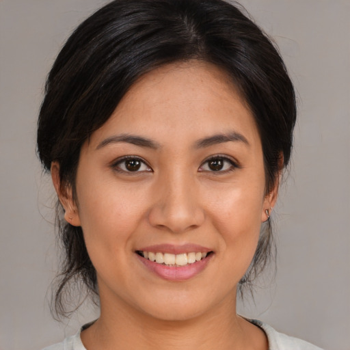 Joyful asian young-adult female with medium  brown hair and brown eyes