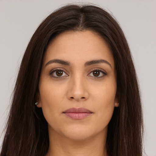 Joyful white young-adult female with long  brown hair and brown eyes