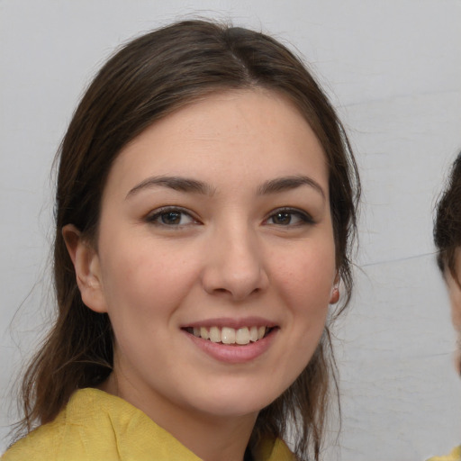 Joyful white young-adult female with medium  brown hair and brown eyes