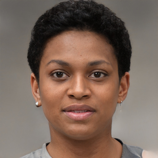 Joyful black young-adult female with short  black hair and brown eyes