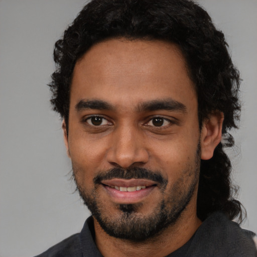 Joyful black young-adult male with short  black hair and brown eyes