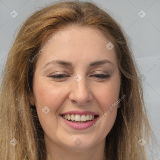 Joyful white adult female with long  brown hair and brown eyes