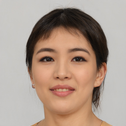Joyful asian young-adult female with medium  brown hair and brown eyes