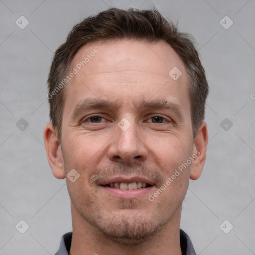 Joyful white adult male with short  brown hair and grey eyes