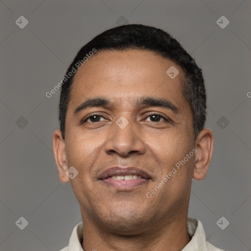 Joyful latino adult male with short  black hair and brown eyes