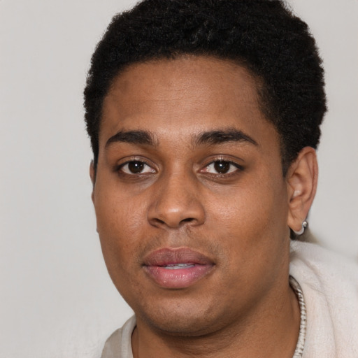 Joyful black young-adult male with short  black hair and brown eyes