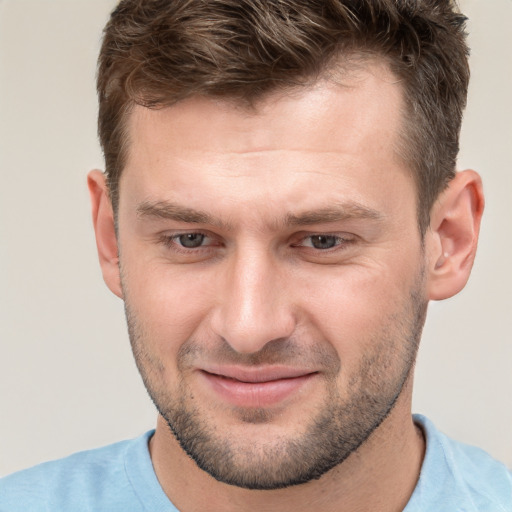 Joyful white adult male with short  brown hair and brown eyes