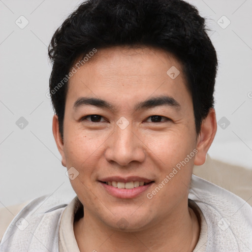 Joyful asian young-adult male with short  brown hair and brown eyes