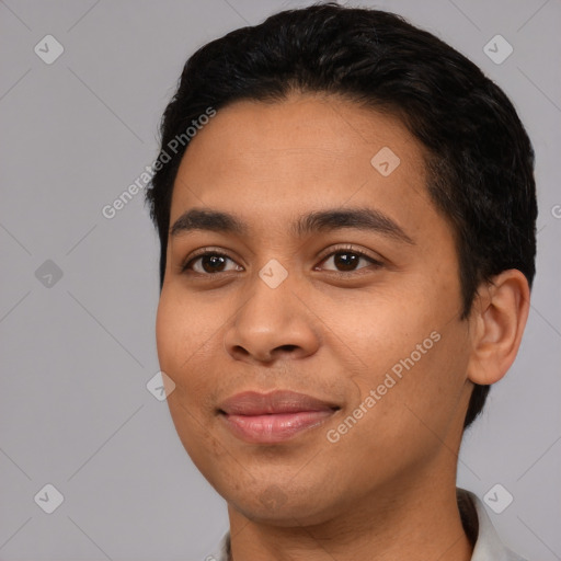 Joyful latino young-adult male with short  black hair and brown eyes