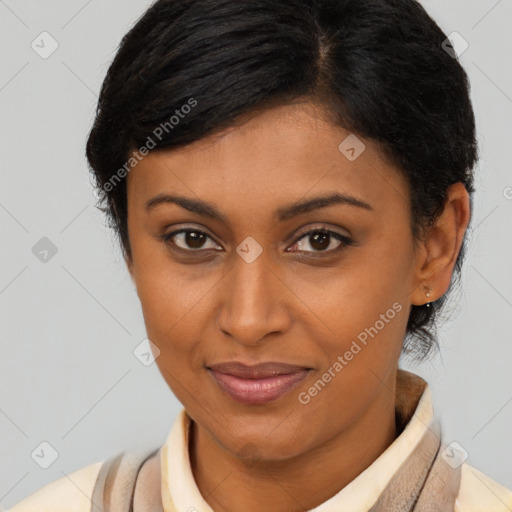 Joyful latino young-adult female with short  brown hair and brown eyes