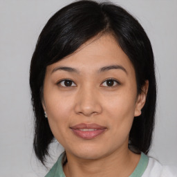 Joyful asian young-adult female with medium  black hair and brown eyes