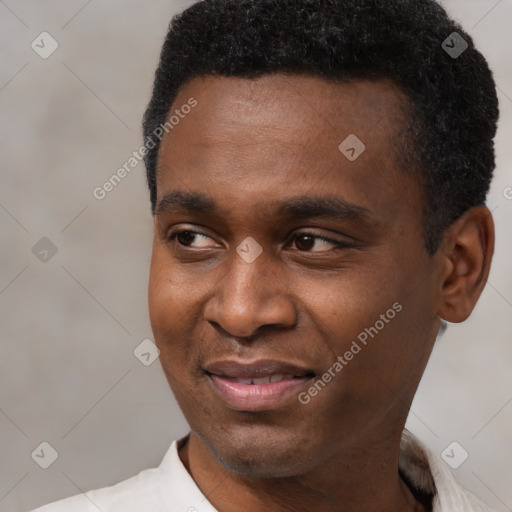 Joyful black young-adult male with short  black hair and brown eyes