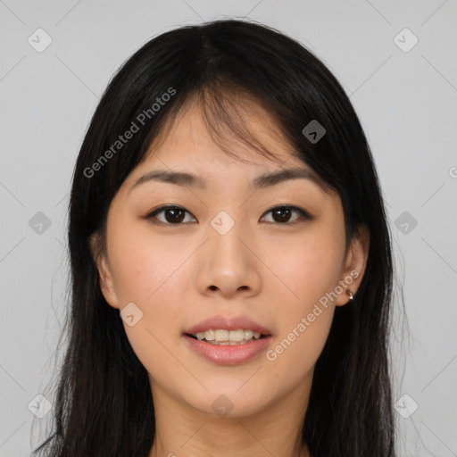 Joyful asian young-adult female with long  brown hair and brown eyes