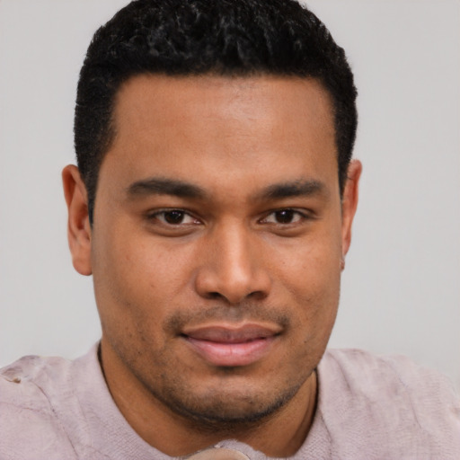 Joyful latino young-adult male with short  black hair and brown eyes