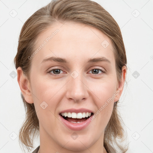 Joyful white young-adult female with medium  brown hair and blue eyes