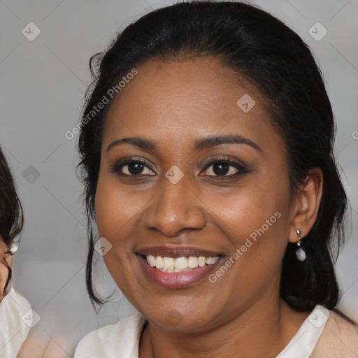 Joyful black young-adult female with medium  brown hair and brown eyes