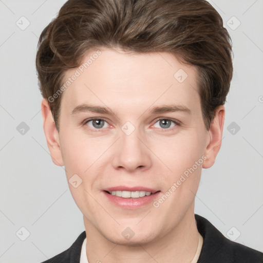 Joyful white young-adult male with short  brown hair and grey eyes