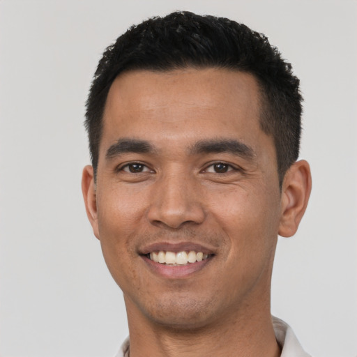 Joyful asian young-adult male with short  black hair and brown eyes