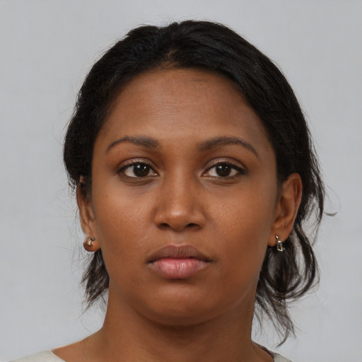 Neutral black young-adult female with medium  brown hair and brown eyes