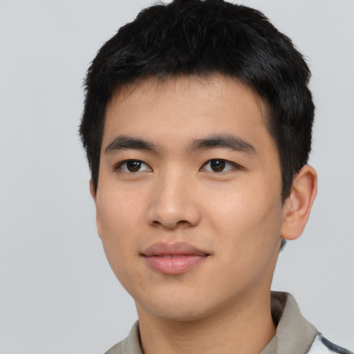 Joyful asian young-adult male with short  black hair and brown eyes