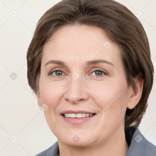 Joyful white adult female with medium  brown hair and grey eyes