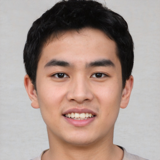 Joyful asian young-adult male with short  black hair and brown eyes