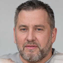 Joyful white middle-aged male with short  brown hair and brown eyes