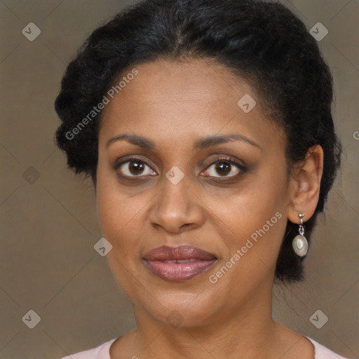 Joyful black adult female with medium  brown hair and brown eyes