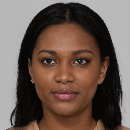 Joyful black young-adult female with long  black hair and brown eyes