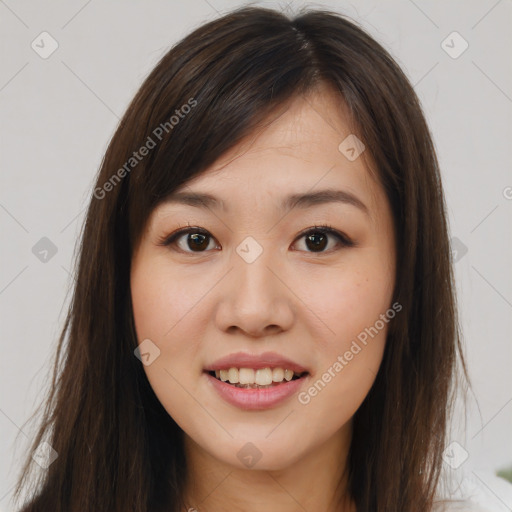 Joyful asian young-adult female with long  brown hair and brown eyes