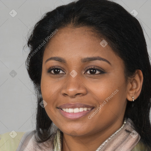 Joyful black young-adult female with long  brown hair and brown eyes